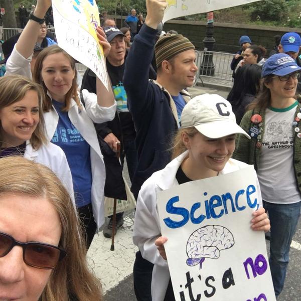 March for Science--several people holding up handmade posters about science
