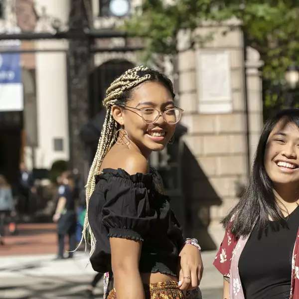 2 Barnard students near the Barnard gate